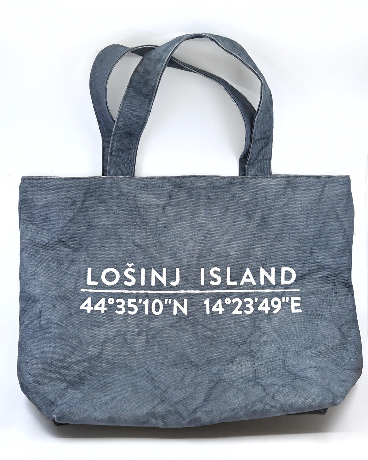 Oversized cotton canvas shopper bag in grey with white screen printed Lošinj Island coordinates design on one side.