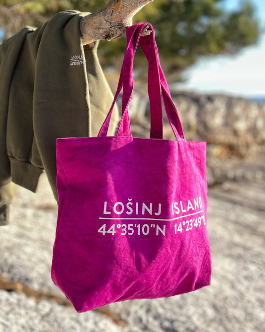 Oversized cotton canvas shopper bag in pink with white screen printed Lošinj Island coordinates design on one side.