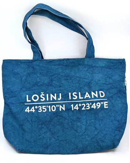 Oversized cotton canvas shopper bag in teal with white screen printed Lošinj Island coordinates design on one side.