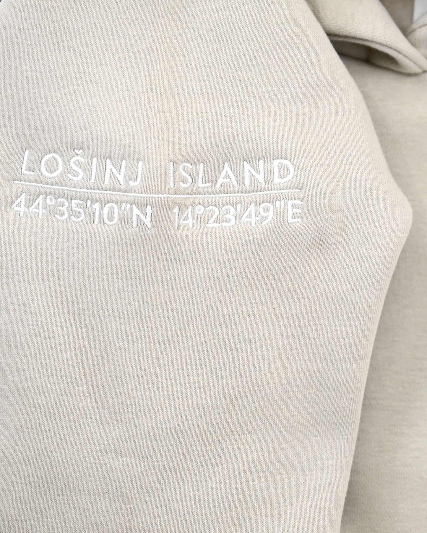 Premium, heavy hoodie  with Lošinj island coordinates stitched on the sleeve.