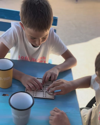 Video of two boys playing the wooden tic tac toe game with engraved Lošinj Island coordinates and Bongolala details.